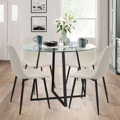 a glass table with four chairs around it