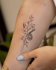 a woman with a flower tattoo on her arm