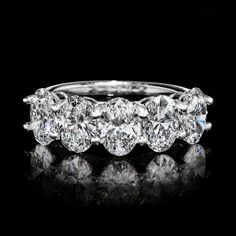 three stone diamond ring on black background