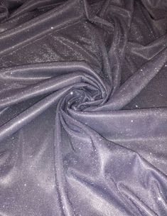 the fabric is shiny and has some silver glitters on it's surface,