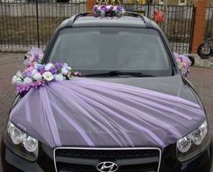 a car decorated with purple and white flowers