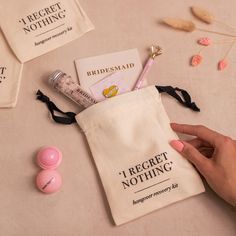 a person holding a toothbrush in a bag next to other items on a table