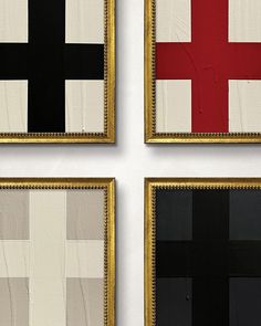 three framed art pieces with black, white and red squares on them in gold frames