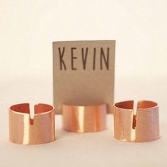 three rings with the word kevin on them sitting next to each other in front of a sign