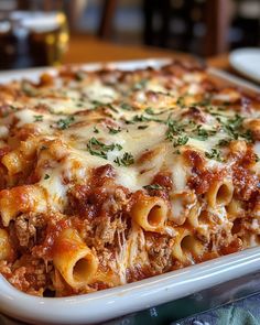 a casserole dish with meat, cheese and sauce