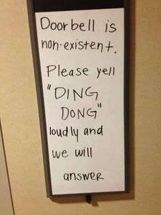 a sign that is on the wall in front of a door with words written below it