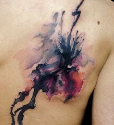 the back of a woman's body with watercolor paint on it