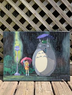 an image of a person holding an umbrella in the rain with a cartoon character on it