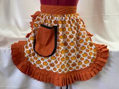 an orange and white apron with pumpkins on it