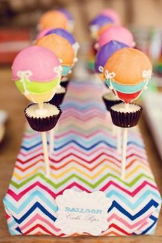 colorful cupcakes are sitting on top of each other