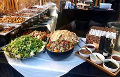 a buffet table filled with lots of food and condiments on top of it