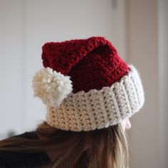 a woman wearing a red and white knitted hat