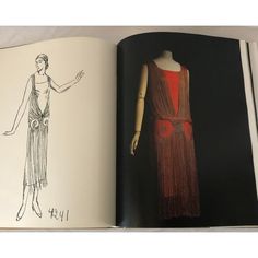 an open book with a drawing of a woman's dress