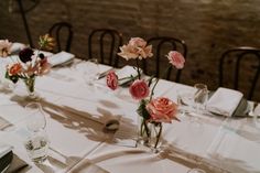 there are many flowers in vases on the table at this wedding dinnereonary