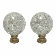 pair of glass door knobs with brass finish on each side and white speckled design