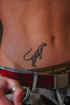 a close up of a person with a tattoo on their stomach and the bottom half of his body