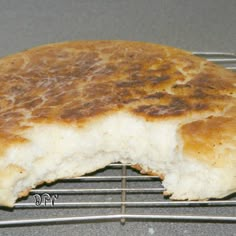 a piece of bread sitting on top of a metal rack