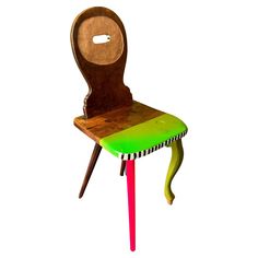 a wooden chair that has been painted green and red