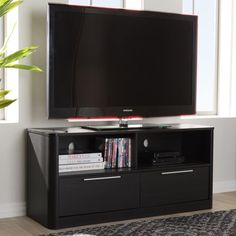 a flat screen tv sitting on top of a black entertainment center