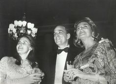 an old black and white photo of two women and a man standing next to each other