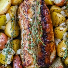 grilled pork with potatoes and herbs on a platter