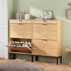 a wooden cabinet with shoes on it in a room