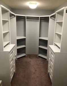 an empty walk in closet with shelves and drawers