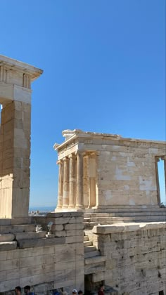 some people are walking around in front of the ruins at acrobatia, greece