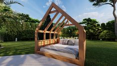 a wooden bed sitting in the middle of a lush green field next to a tree