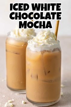 two iced white chocolate mochas with whipped cream on top