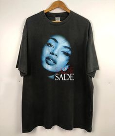 a black t - shirt with the words sade on it