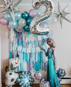 a frozen princess birthday party with balloons, streamers and decorations for her 6th birthday