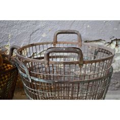 two metal baskets sitting next to each other