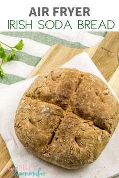 a loaf of irish soda bread sitting on top of a wooden cutting board