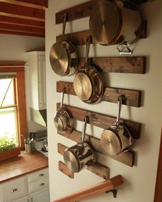 pots and pans are hanging on the wall