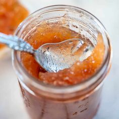 a spoon in a jar filled with jam