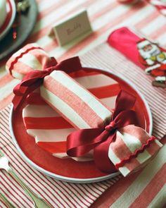 red and white striped table cloth with napkins, silverware and utensils