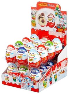 an assortment of christmas themed eggs in a display case with santa's helpers on them