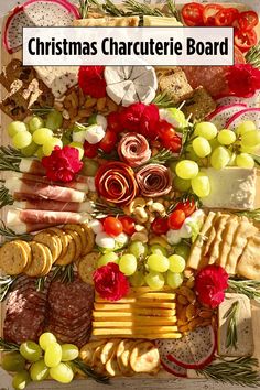 christmas charcute board with cheese, crackers, grapes and meats on it