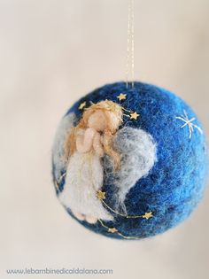 a blue ornament with an angel on it