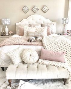 a white bed sitting in a bedroom next to a window