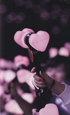 a person holding a hair dryer in their hand with lots of hearts on it