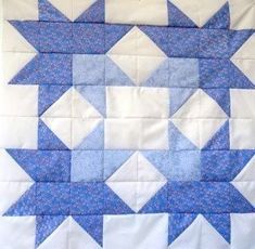 a blue and white quilt with stars on it