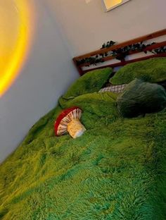 a green bedspread with seashells on it and a yellow light in the background