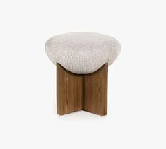 a small stool with a wooden base and white upholstered cushion