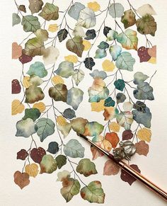 watercolor painting with leaves and paintbrush on white paper