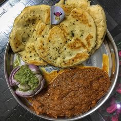 a metal plate topped with different types of food