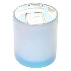 a blue glass candle with a white lid