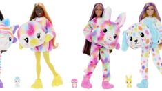 three dolls are dressed in colorful animal costumes and one is holding a stuffed animal doll