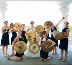 a group of women standing next to each other holding musical instruments